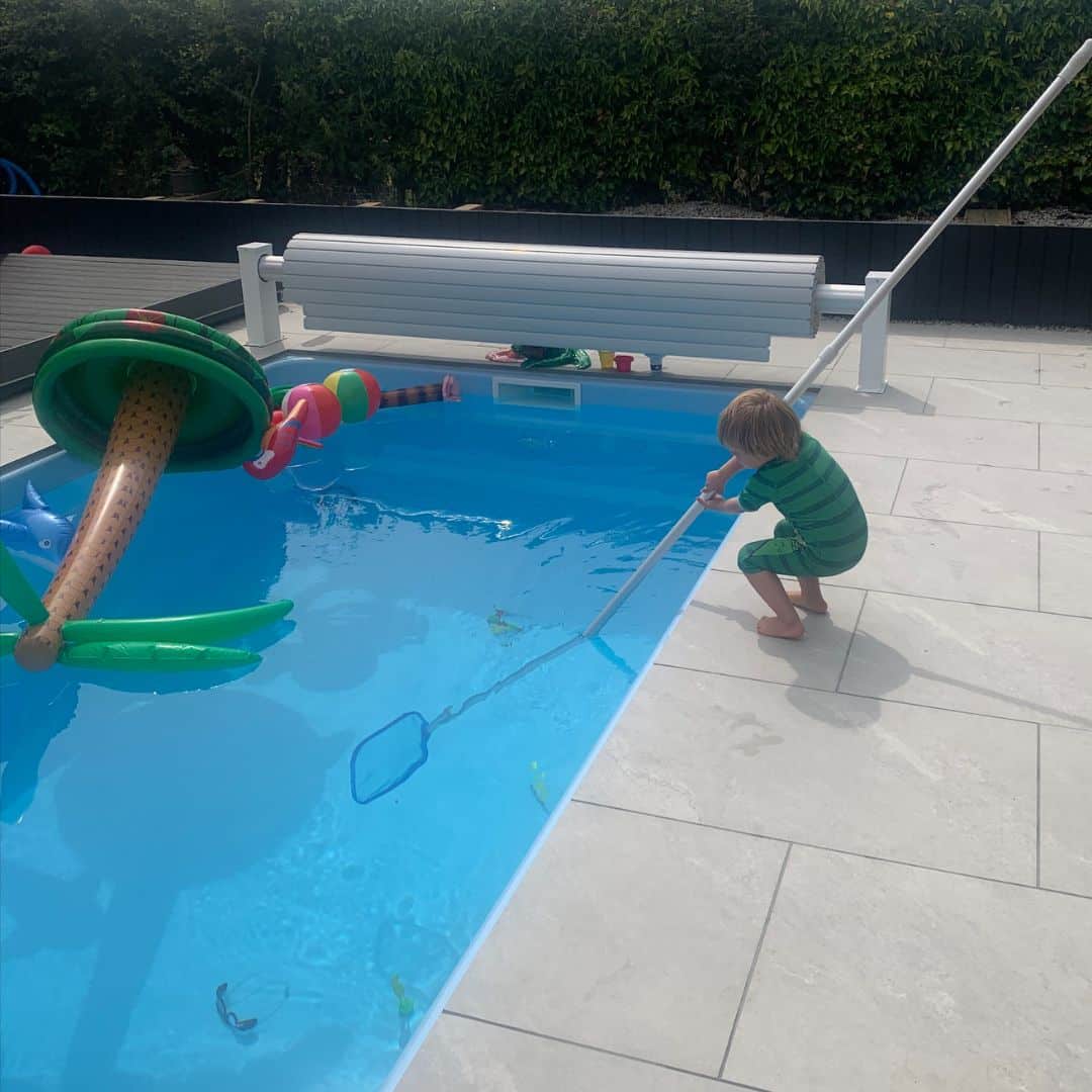 Little Kid Skimming a Pool