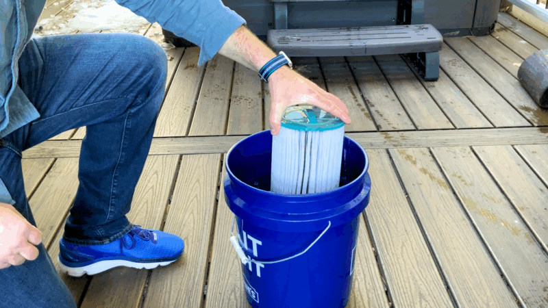 Adding hot tub filter to bucket for deep cleaning